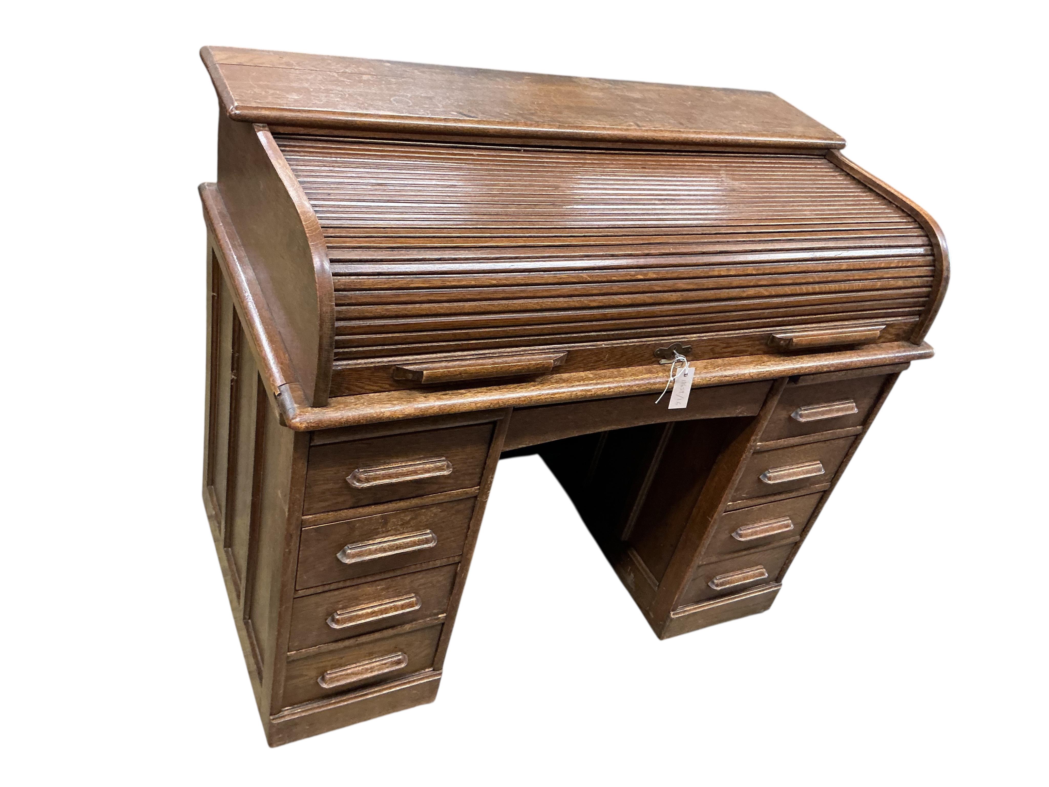 An early 20th century oak roll top desk, width 122cm, depth 66cm, height 101cm
